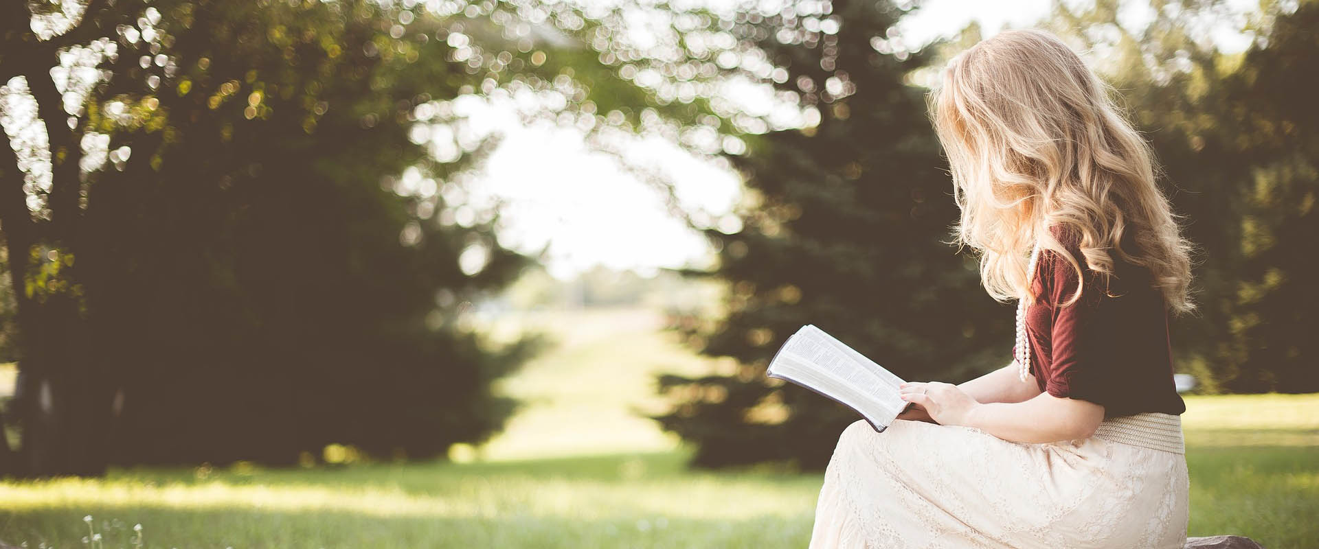 Young lady reading outdoors