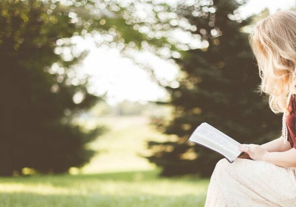 Young lady reading outdoors